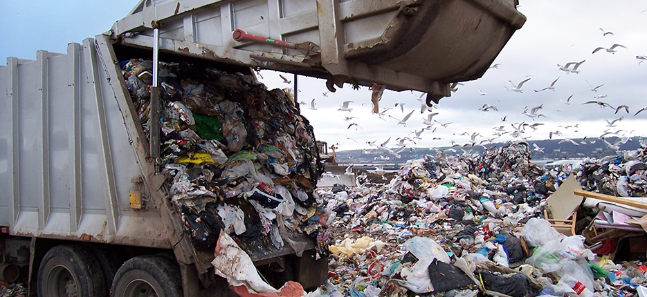 garbage truck dumping at landfill